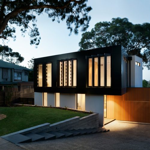 brown and white concrete building near green trees during daytime